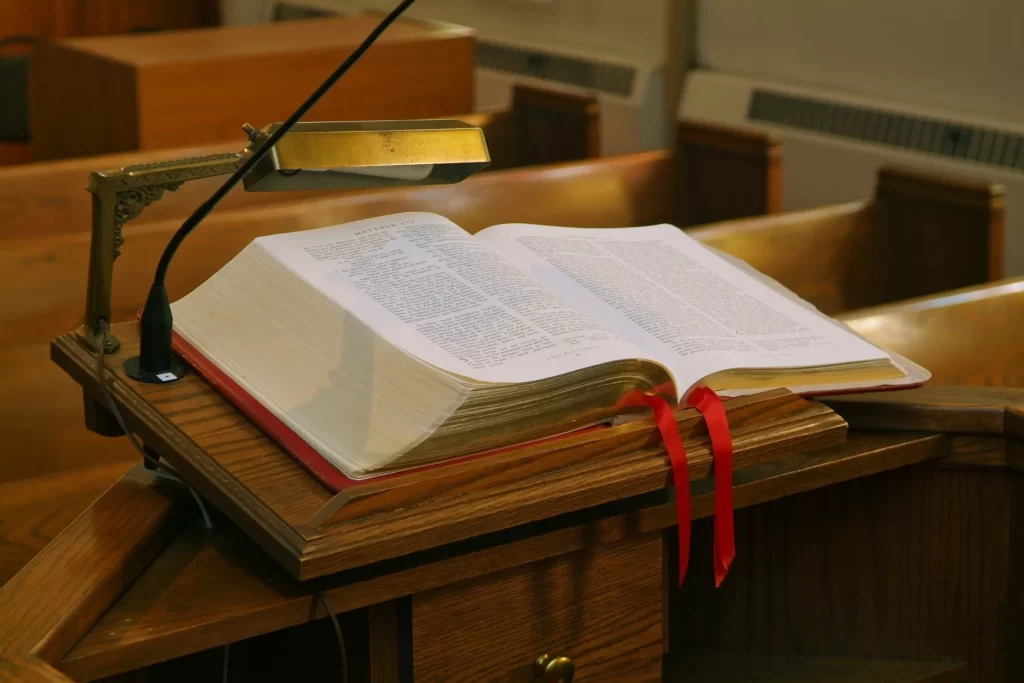 open bible on a pedestal